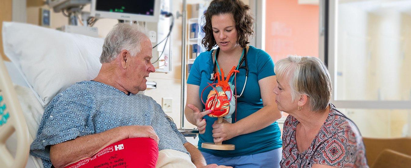 Cardiac patient Jim Mackinaw looks on while nurse navigator Melissa Hogan provides heart related information.